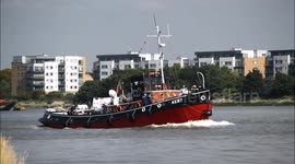 Historic tug heads up the River Thames in London