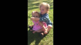 Deaf girl teaches her deaf sister how to sign 'bird' in American Sign Language.