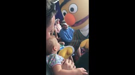 Baby gives adorable hug to Bert from Sesame Street