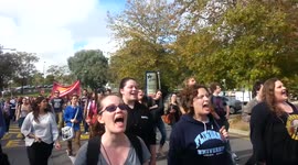 Flinders University students march to the Mark Oliphant Building to protest Tony Abbott's budget