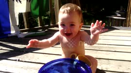 Laughing Baby Splashes in Bowl of Water