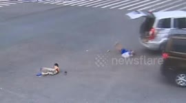 Children fall out of back of vehicle onto road after crash