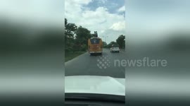 Newsflare Edit - Indian school children pull risky stunt on bus roof  - police probe follows