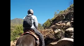 Lesotho. Malealea. Pony Trek. Botsoela waterfall & San paintings (3) Going up with rocks riding horse
