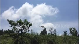 Plane dumping water on a forrest fire in italy