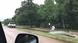 Man wakeboards in flooded ditch after Hurricane Harvey