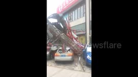 Typhoon downs huge billboard smashing vehicles