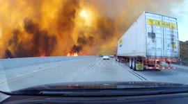 Slow motion dash cam footage shows LA fire engulf freeway