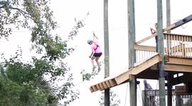 Alligator leaps out the water to try and bite a passing zipline instructor