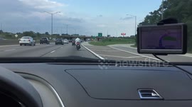 Guy Riding Motorcycle in Hazmat Suit