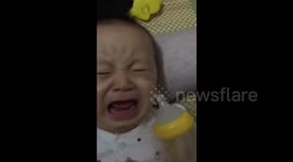 Sleepy baby scared by father's sneeze