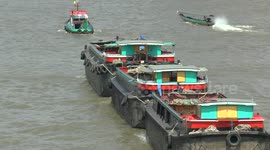 Tug boat hauling empty barges in Bangkok