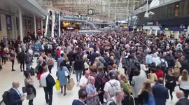 Crowds of people wait for delayed trains at London Waterloo