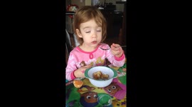Sleepy toddler tries to eat pancakes