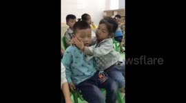 Kindergarten girl protects sleepy boy from falling down
