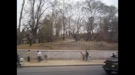 North Korea. DPRK. Pyongyang IV. Traffic and workers fixing sidewalk. 2015
