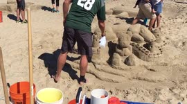 Artist working on Beagle & Teddy Bear Sand Sculpture for 39th Annual Contest