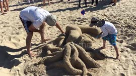 Man Works on Mermaid Sand Sculpture for 39th Annual Contest
