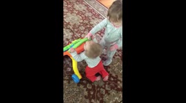 Big sister helps her little sister walking