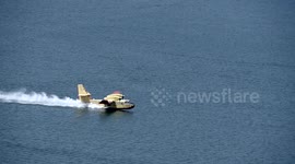 super scooper slow motion aircraft skimming lake