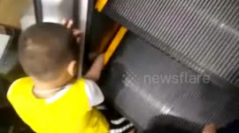 Chinese boy gets hand stuck in escalator
