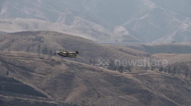 super scooper long slow motion climbout in mountainous terrain