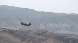 super scooper long slow motion climbout in mountainous terrain