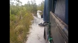 Madagascar. Full truck crossing puddles north of Soanierana-Ivongo. 2015
