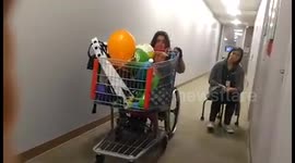 Woman Learning to Push a Grocery Cart In A Wheelchair