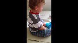Baby dancing to the rhythm of a washing machine