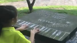 Girl practices piano on table with chalked keyboard