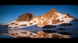Time-lapse footage of mountain scenes across North America
