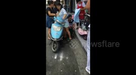 Woman on scooter gives birth in street