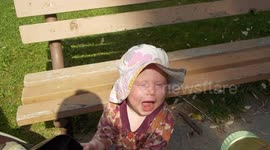 Cute Baby Drinking Water Sprayed from a Baby Bottle