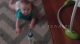 Lazy baby refuses to crawl to grab bottle