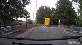 HGV nearly strikes bridge. Blocks road.