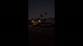 Hot air balloon lands in a busy neighbourhood