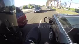 Motorcyclist stops driver with fuel hose still attached to her car