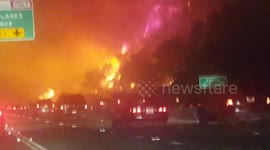Night shots of Canyon fire raging near highway