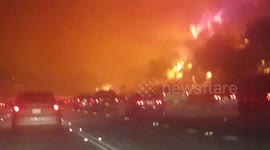 Night shots of Canyon fire raging near highway