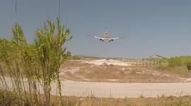 Standing directly beneath plane while landing. Closeup.