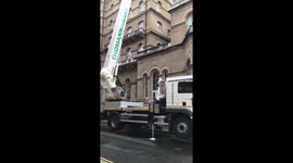 Giant crane in London cleaning The Langham hotel