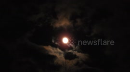 Full Moon with dark ominous clouds passing over creating a Monster Face