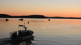 Bar Harbor Maine at Sunrise. Fisherman's Boat heading out.