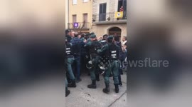 Spanish Guardia Civil charge polling station in Catalan town