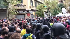 Crowd surrounding riot police
