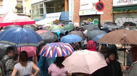 Barcelona residents voting during rain