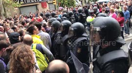 Tense standoff between riot police and Barcelona crowds