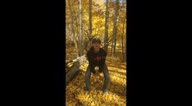 Boy throws fall leaves in air slow motion