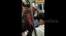 Man breaks out into song on Beijing subway